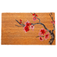 Full view of non-slip natural coir doormat with red and pink cherry blossom branch
