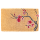 Full view of thick natural coir doormat with red and pink cherry blossom branch