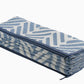Full view of light blue and white chevron foldable outdoor rug folded into a compact stack