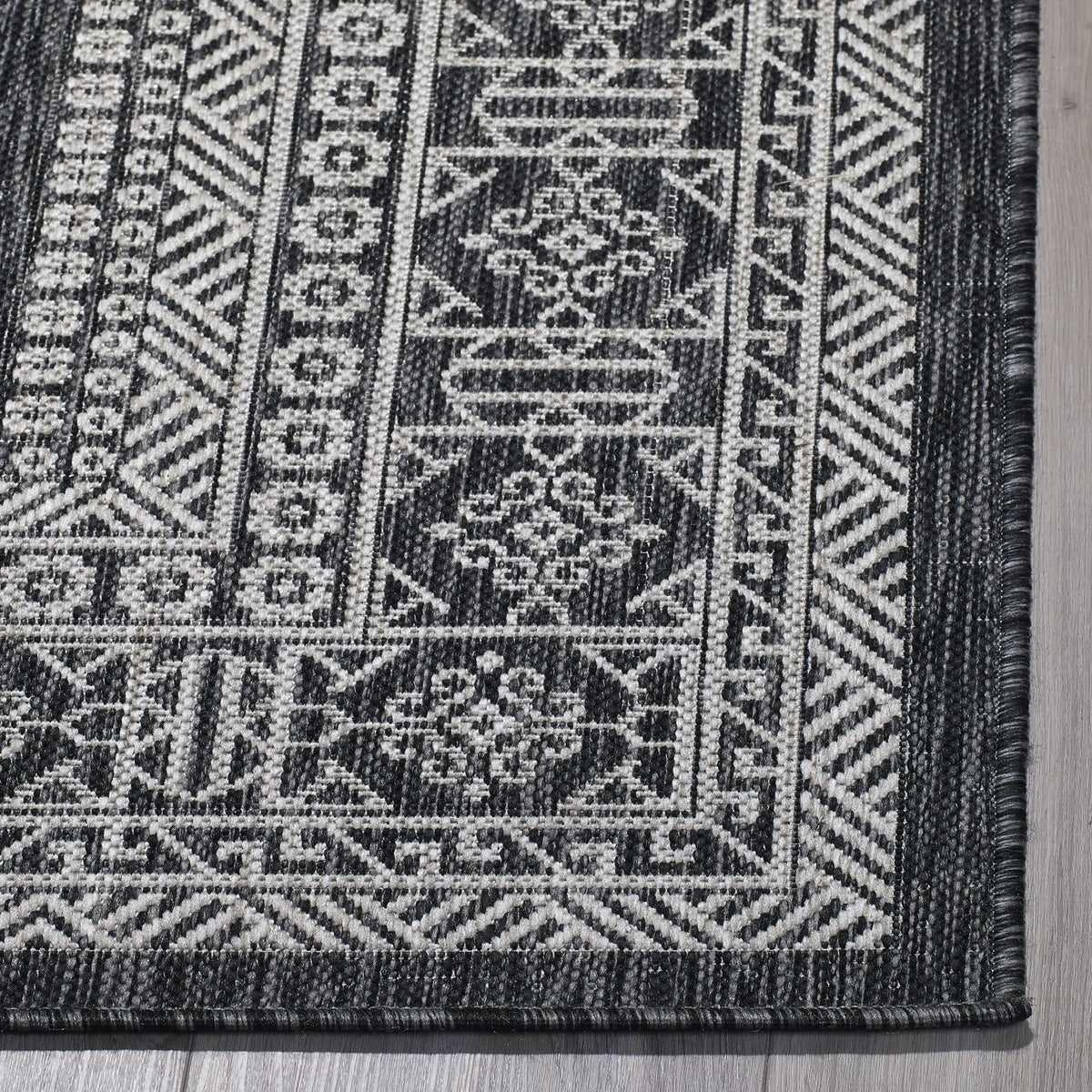 Charcoal Outdoor Rug, folded corner showing woven texture