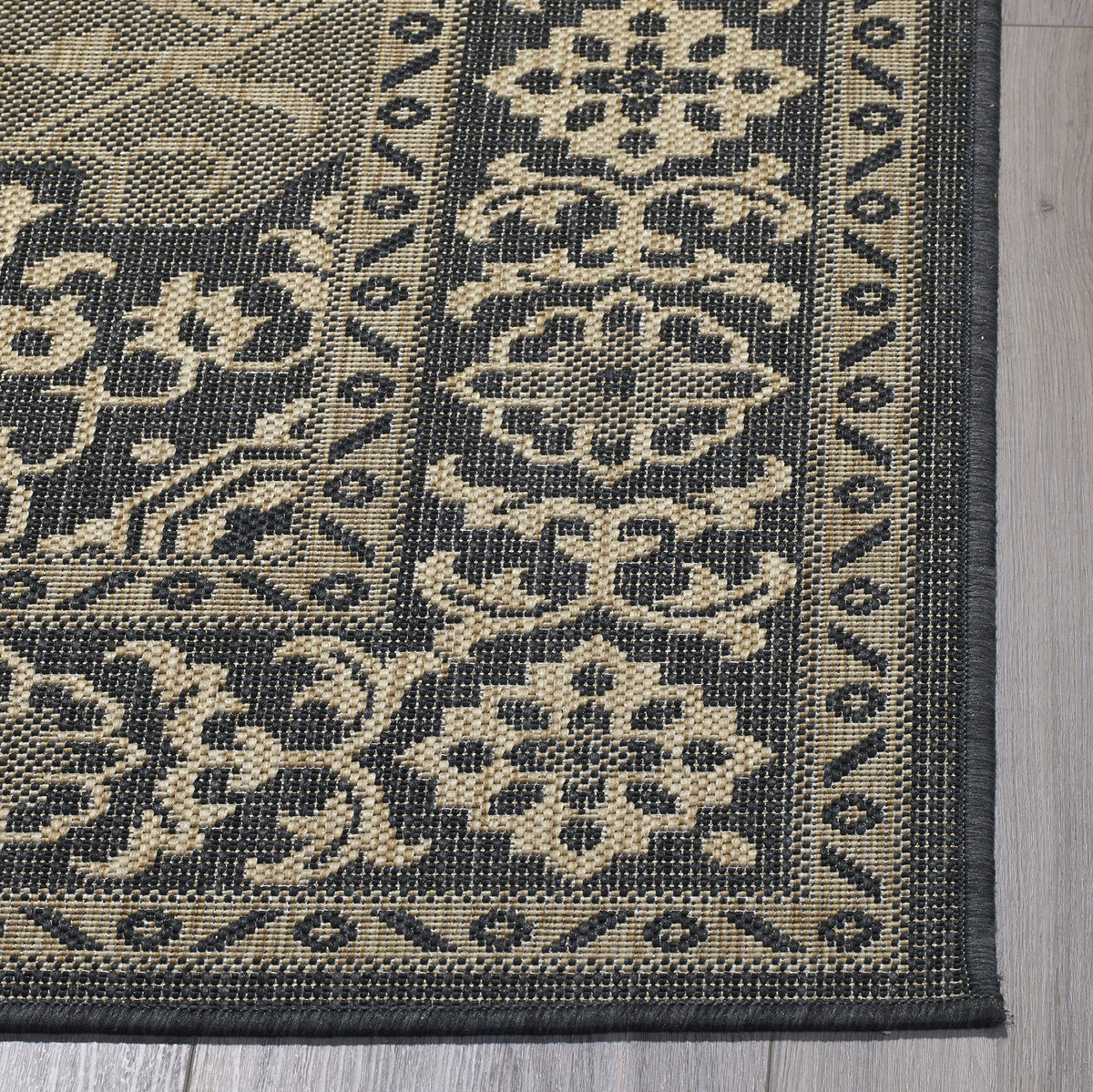 Charcoal Outdoor Rug, folded corner showing woven texture