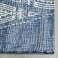 Texture close-up of ivory tribal motif woven into blue outdoor rug