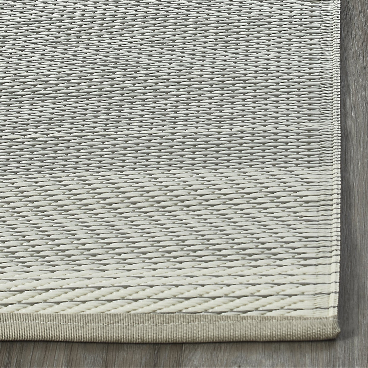 Ash Outdoor Rug, folded corner showing woven texture, Ash tones