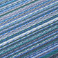 Texture close-up of indigo and blue striped outdoor rug woven stripes