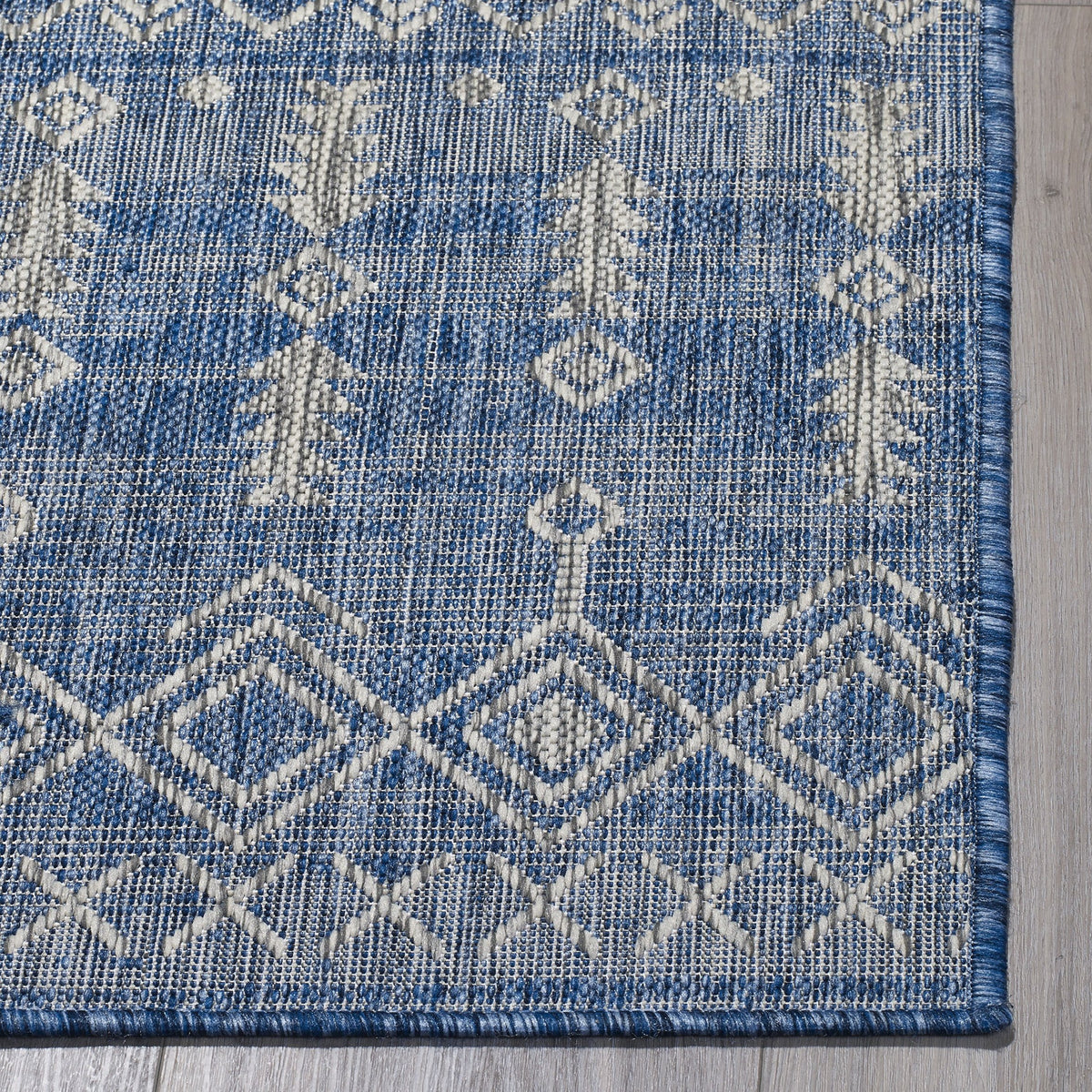 Blue Outdoor Rug, folded corner showing woven texture