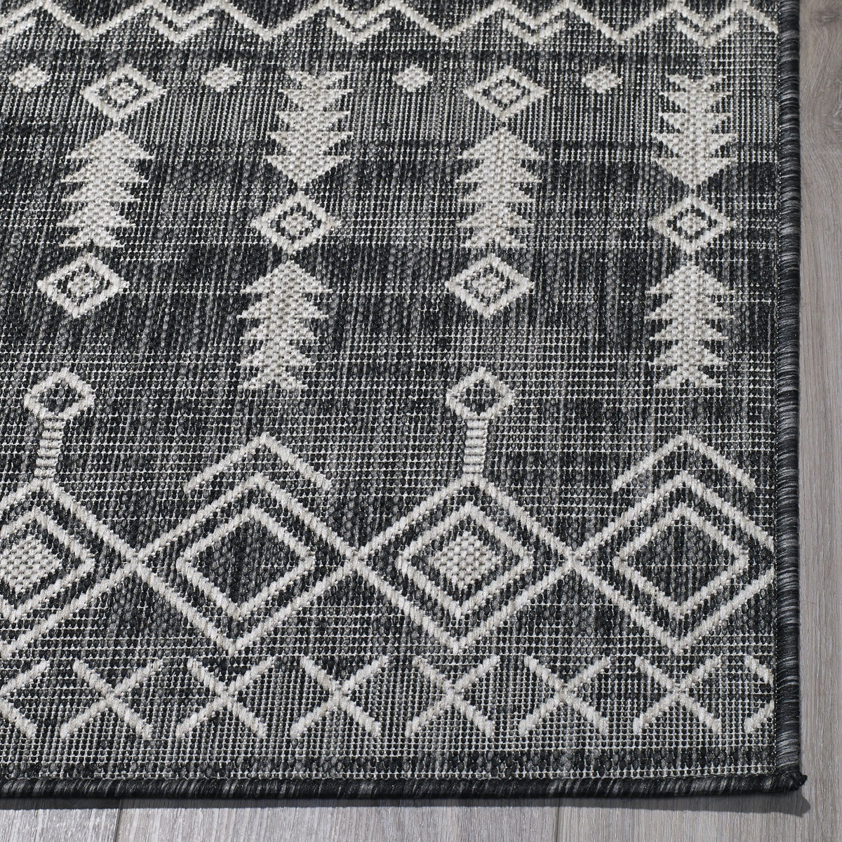 Charcoal Outdoor Rug, folded corner showing woven texture