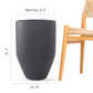 Size guide for large black planter by a chair: 12.5 in opening, 21.5 in high, 15.75 in wide