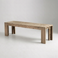 Dune Weathered Natural acacia dining bench on a light gray studio background, angled view