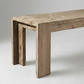 Close up of the end of the Dune acacia bench showing the textured weathered finish and leg profile