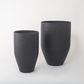 Full view of two empty tall black planters in medium and large sizes