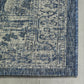 Corner close-up of blue and ivory medallion outdoor rug bound edge