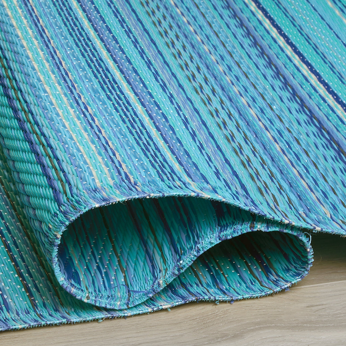 Turquoise Area Rug, folded corner detail, alternate angle