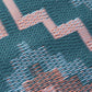 Texture close-up of green diamond outdoor rug showing coral woven strands