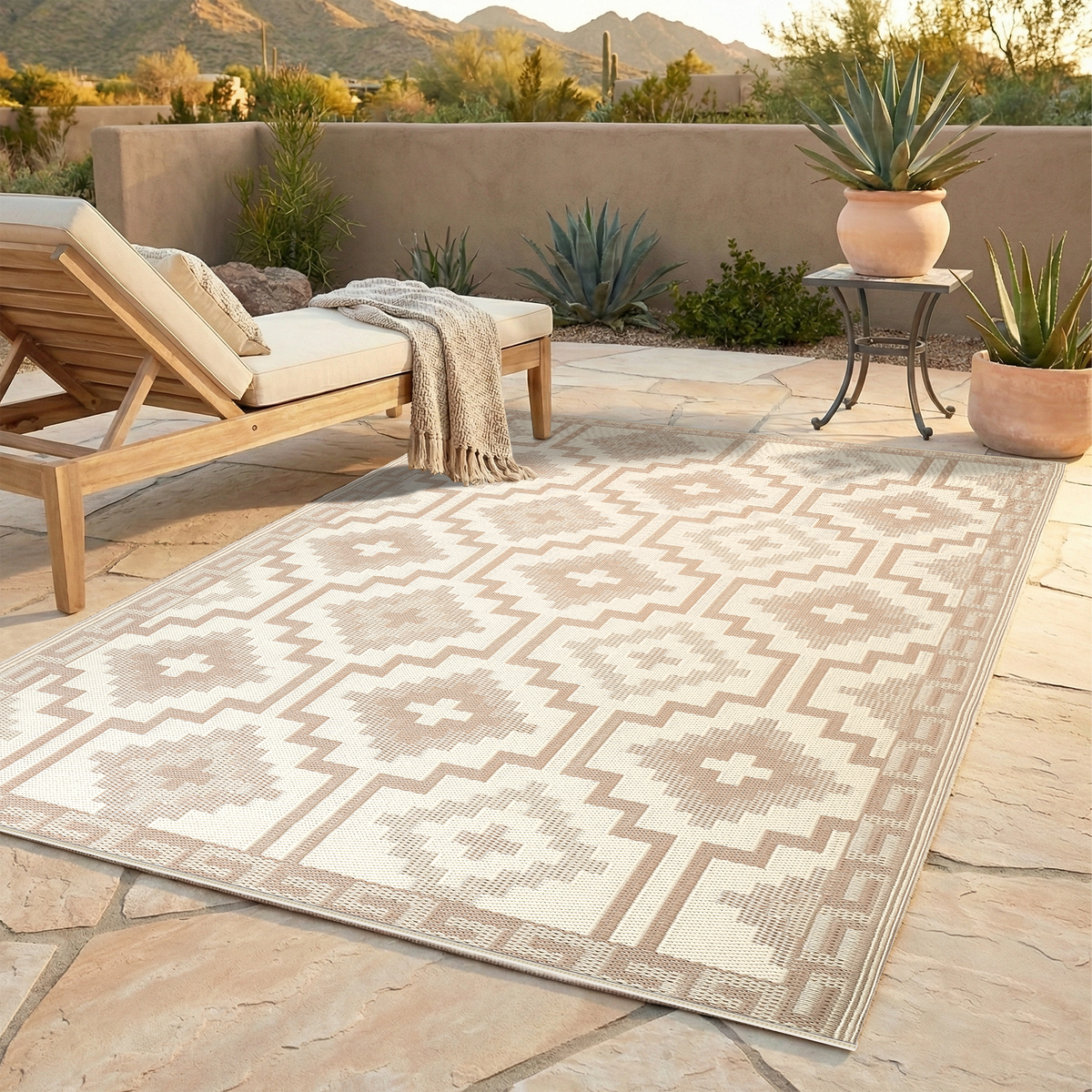 Lifestyle view of mocha diamond outdoor rug beside wooden lounger on desert patio
