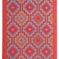 Reverse side of orange and violet diamond outdoor rug with muted mirrored pattern