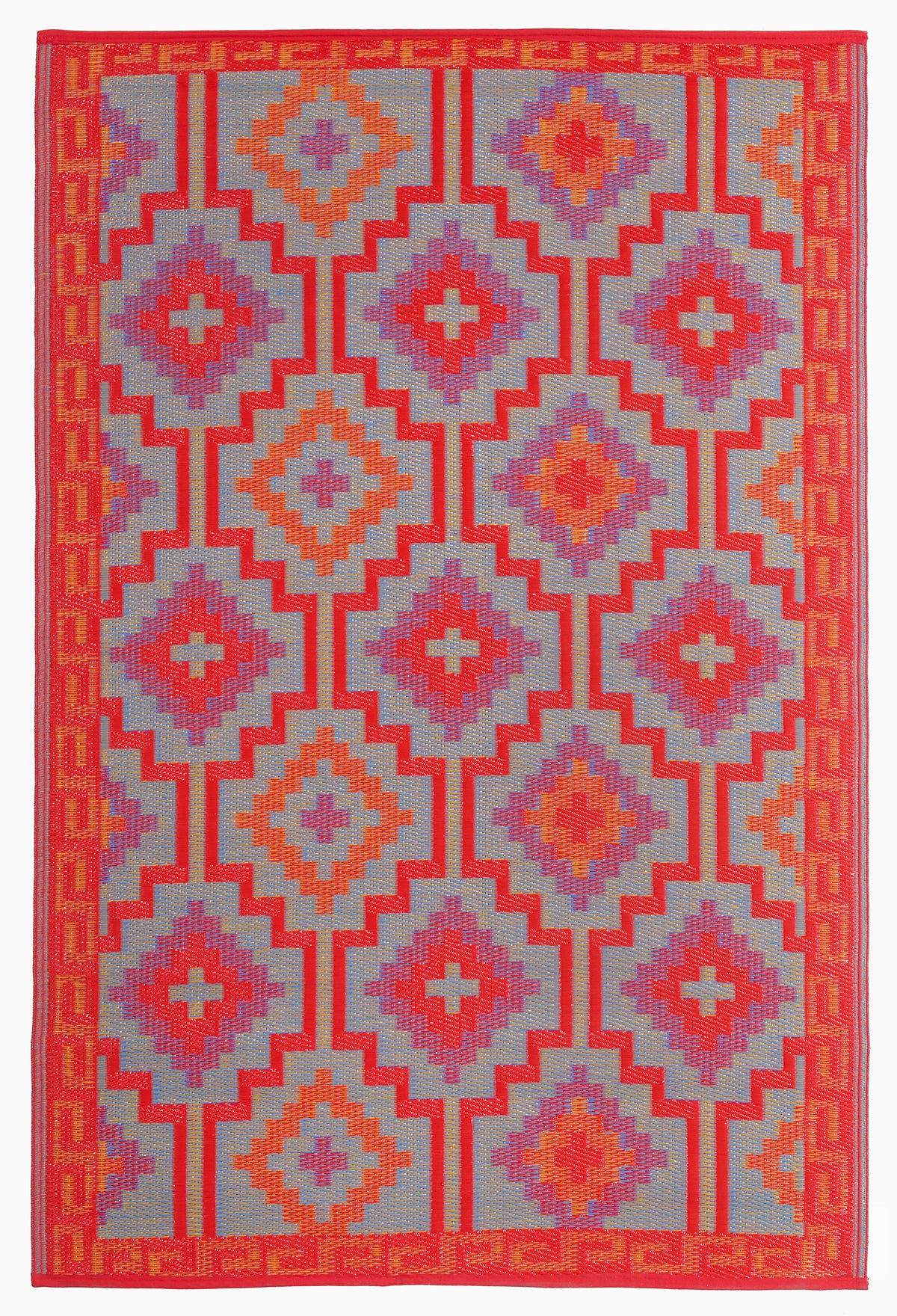 Reverse side of orange and violet diamond outdoor rug with muted mirrored pattern