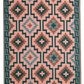 Reverse side of green diamond outdoor rug with coral background
