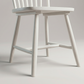 Close up of the turned legs and stretchers under the Linnea Soft White dining chair seat