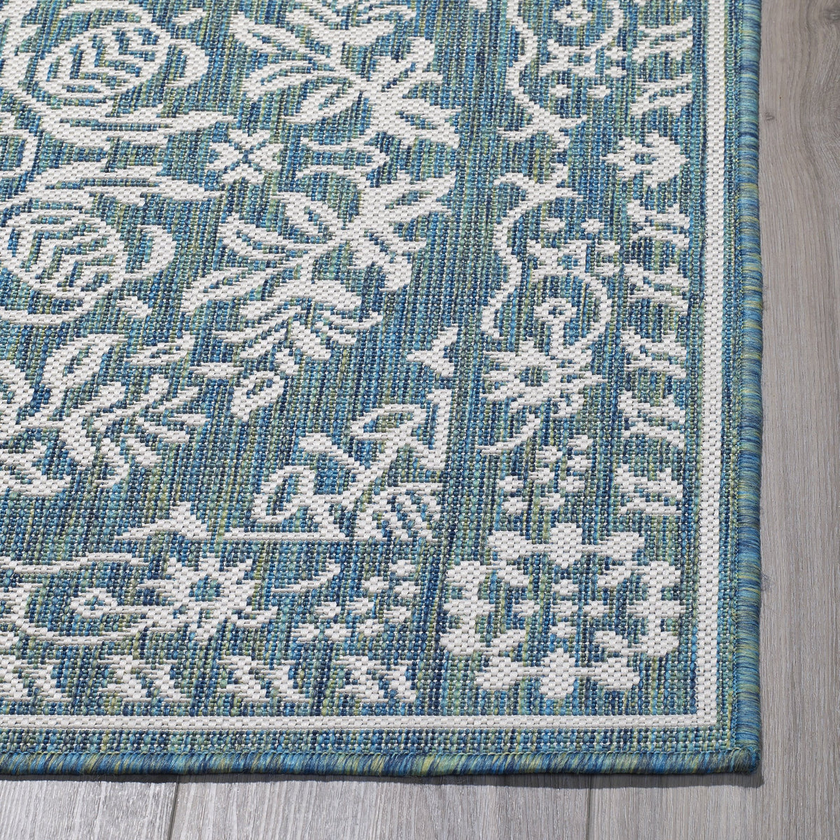 Ocean Outdoor Rug, folded corner showing woven texture