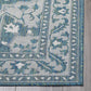 Corner close-up of ocean blue and ivory medallion outdoor rug bound edge