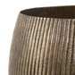 Texture close-up of antique brass planter rim and ribbed hammered side