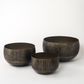 Full view of set of three empty antique brass planters in graduated sizes
