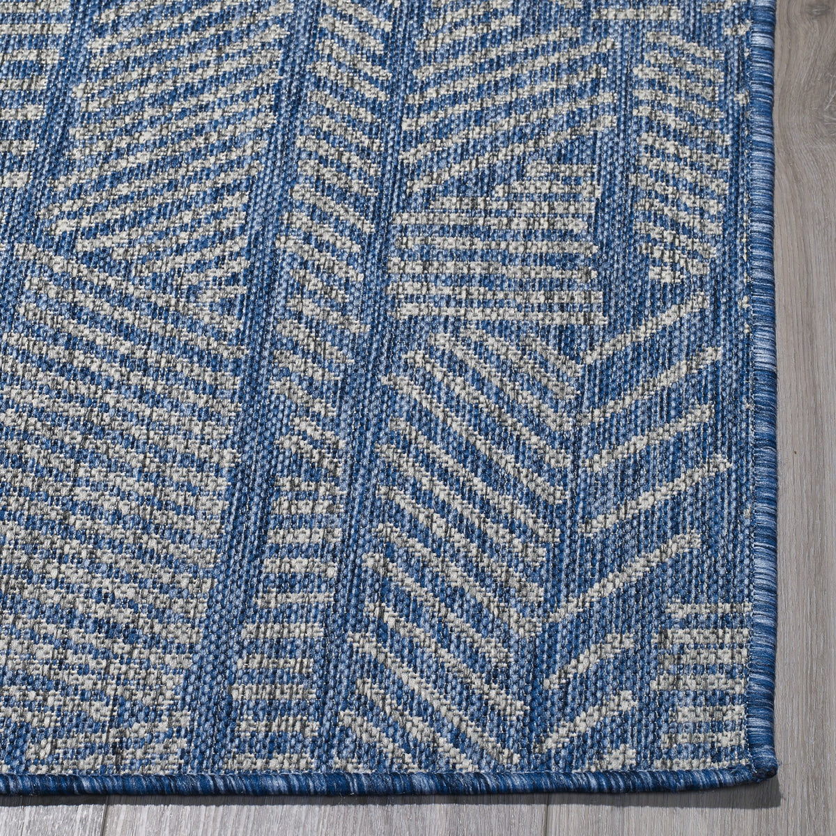 Blue Outdoor Rug, folded corner showing woven texture
