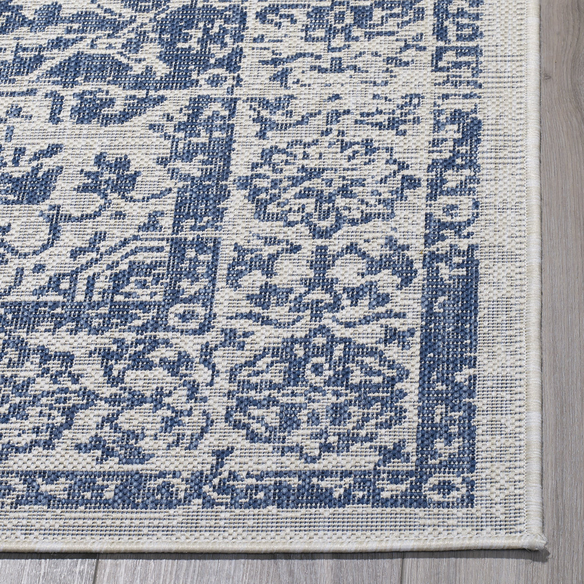 Distressed Blue Outdoor Rug, folded corner showing woven texture