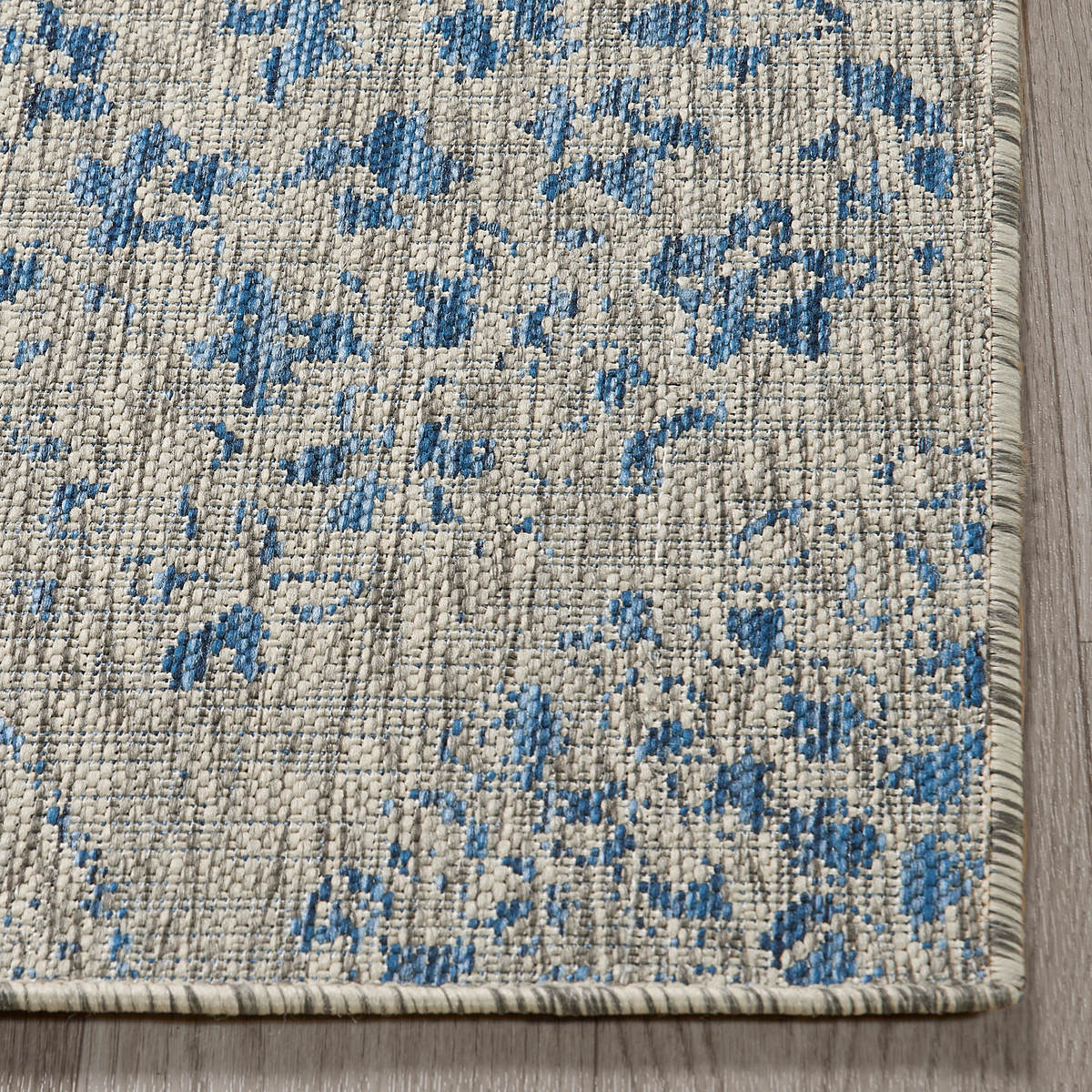 Blue Outdoor Rug, folded corner showing woven texture