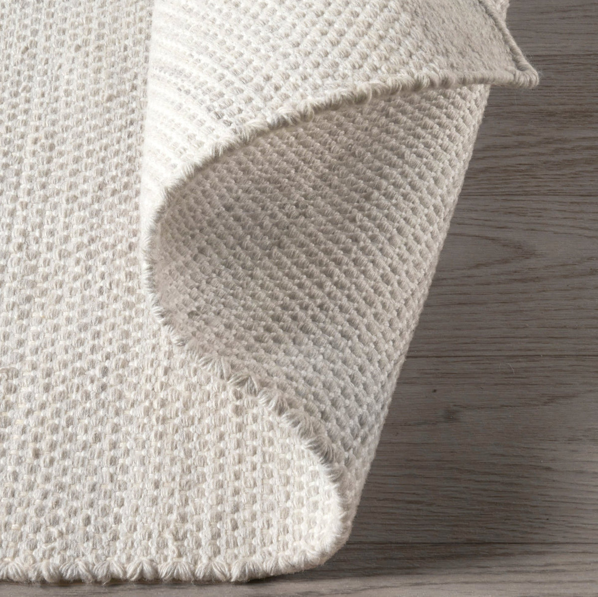 Ivory Outdoor Rug, folded corner showing woven texture