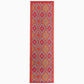 Reverse side of orange and violet diamond outdoor rug in runner size