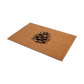 Angled view of wide natural coir doormat with black pine cone