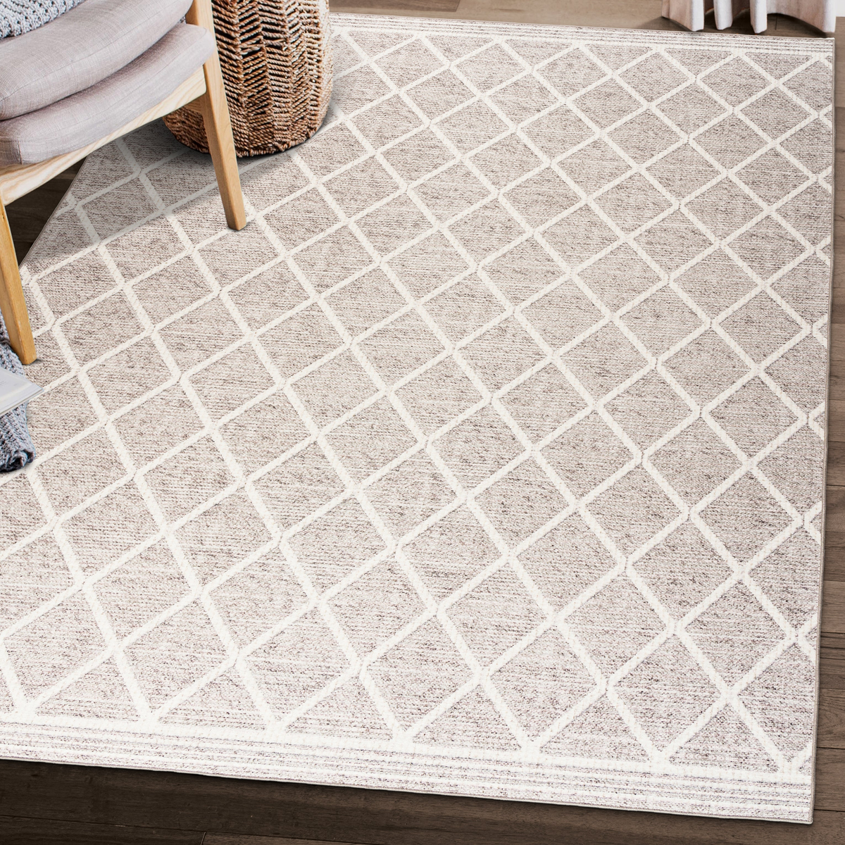 Lifestyle view of beige and ivory lattice machine washable area rug beside woven chair