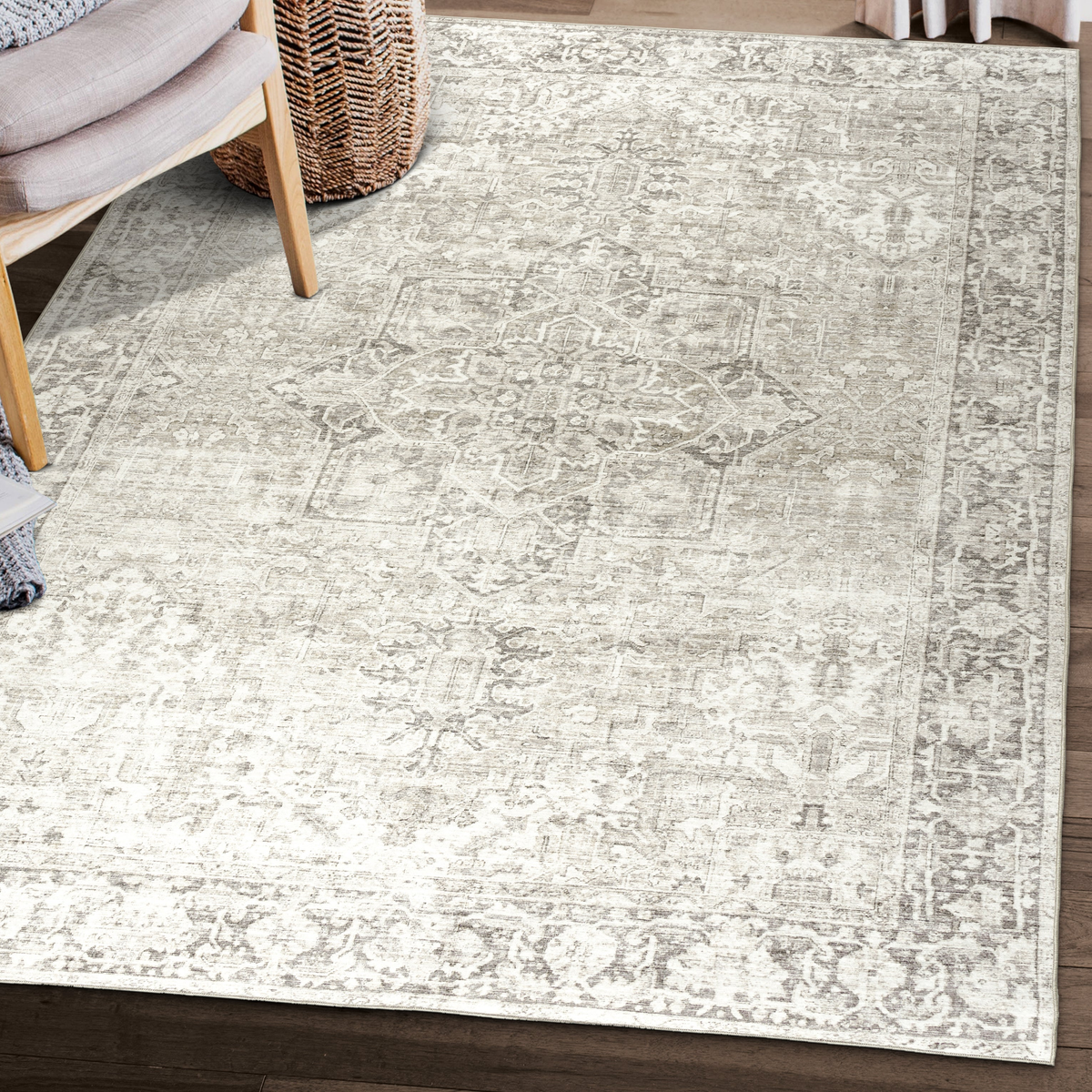 Lifestyle view of beige and ivory traditional machine washable area rug beside woven chair