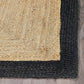 Corner close-up of natural braided jute area rug with black border