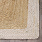 Corner close-up of natural braided jute area rug with ivory border