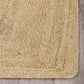 Corner close-up of natural braided jute area rug